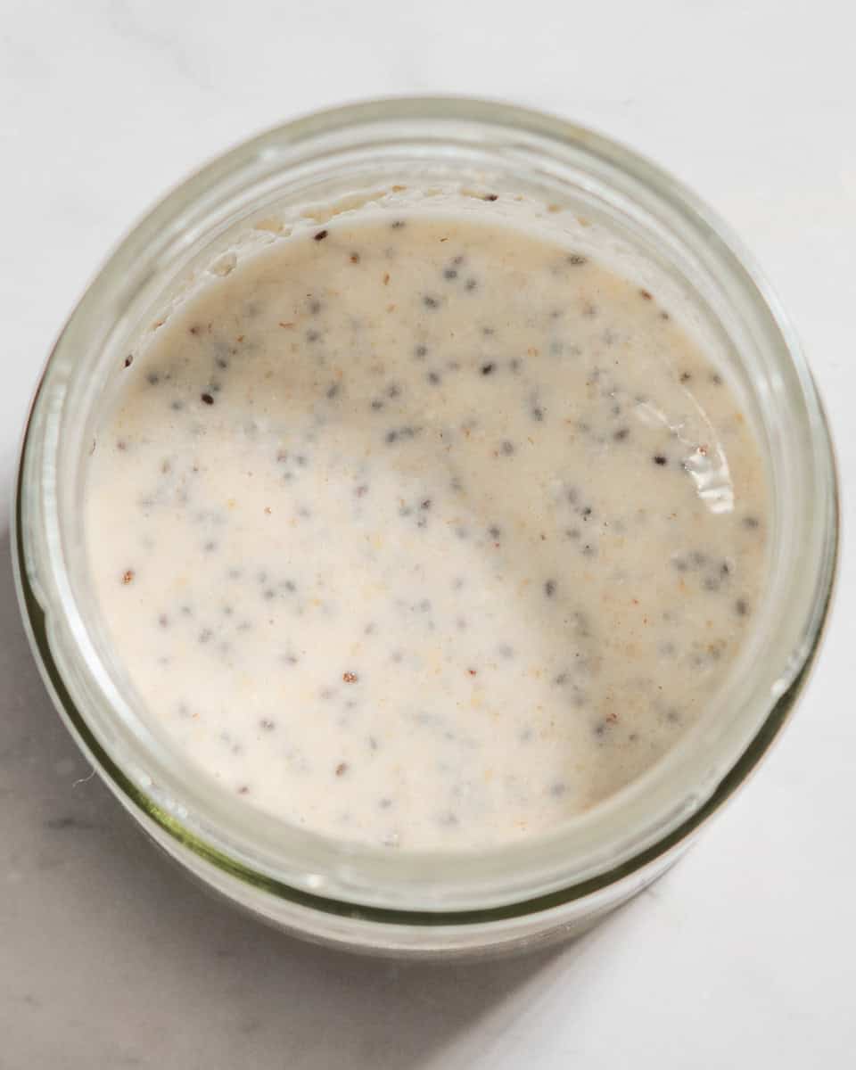 Oats, water and chia seeds whisked together in a jar.