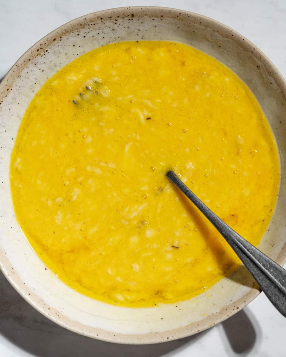 Bananas, oil and eggs mashed in a bowl.