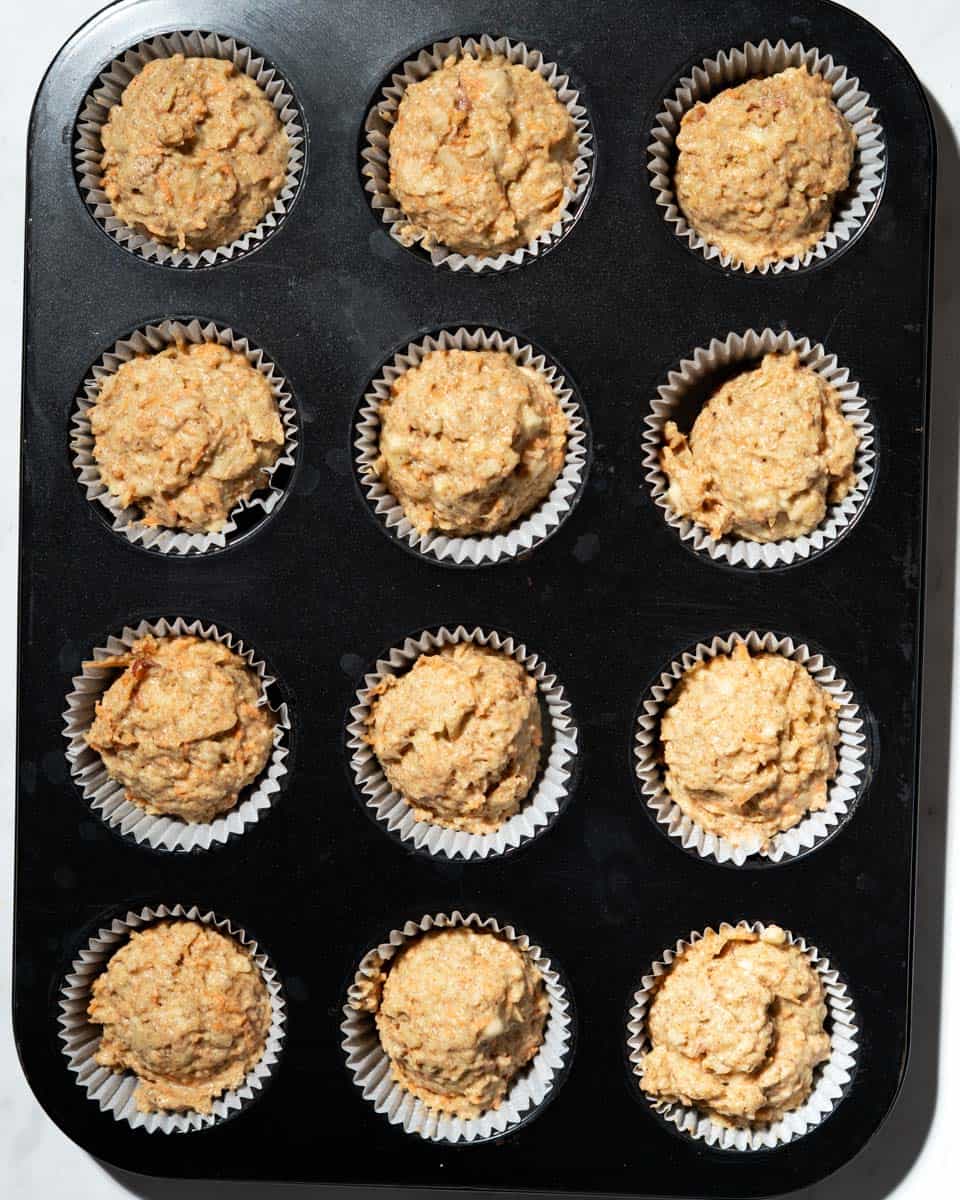 12 ABC muffins in a muffin tin lined with muffin liners.