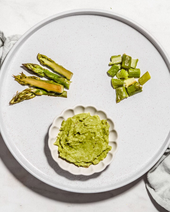 Asparagus chopped and puree on a plate.