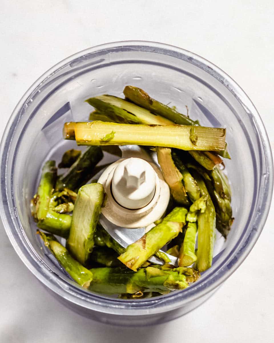 Roasted asparagus in a food processor.