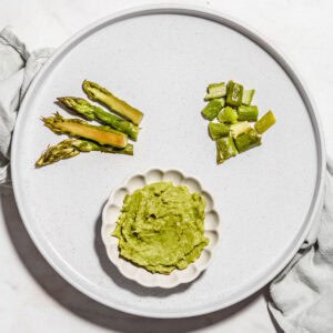 Asparagus chopped and puree on a plate.