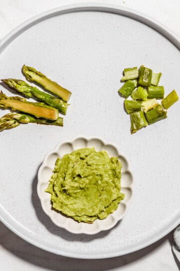 Asparagus chopped and puree on a plate.