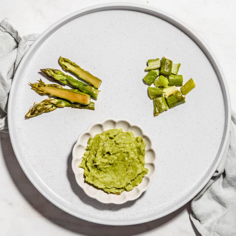 Asparagus chopped and puree on a plate.
