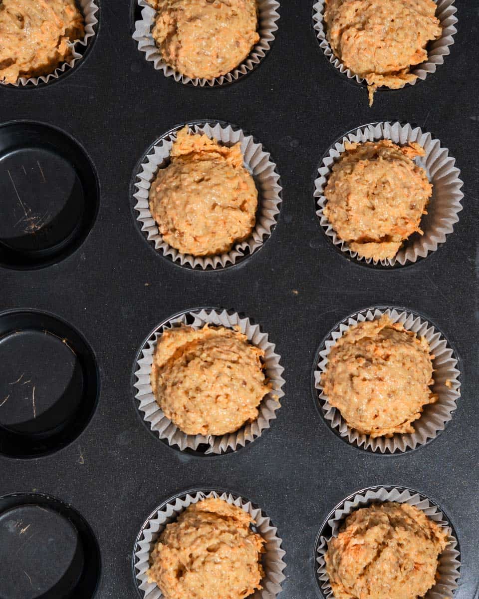 10 muffins in muffins liners and tin ready to be baked.