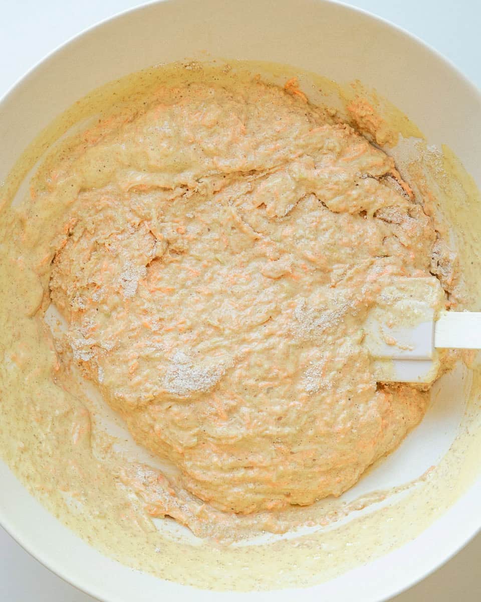 Wet and dry ingredients mixed together in a bowl.