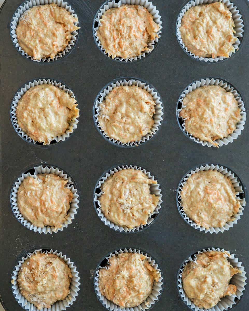 Muffin dough put into 12 individual muffin tin liners.