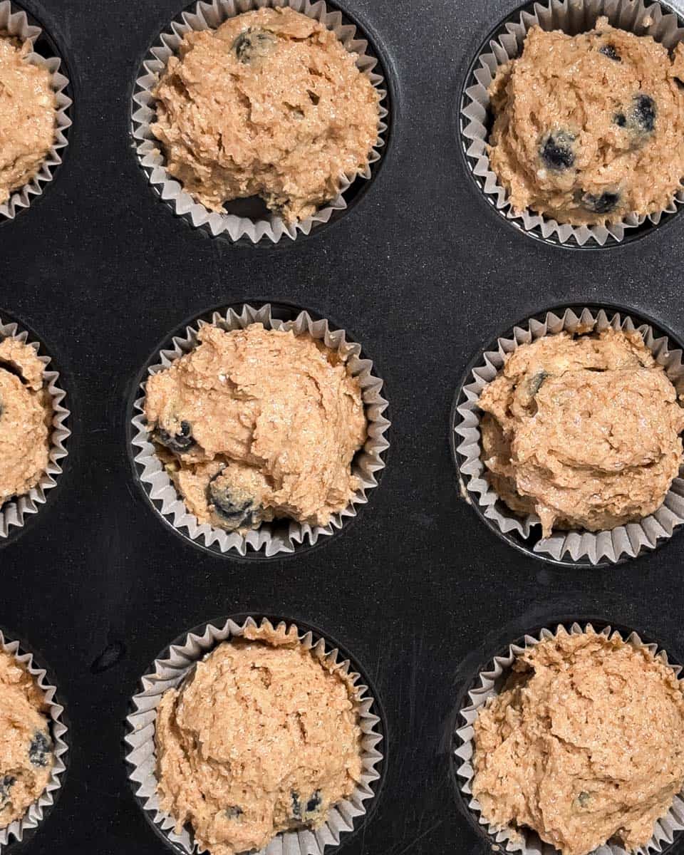 Muffin dough in a muffin tin.