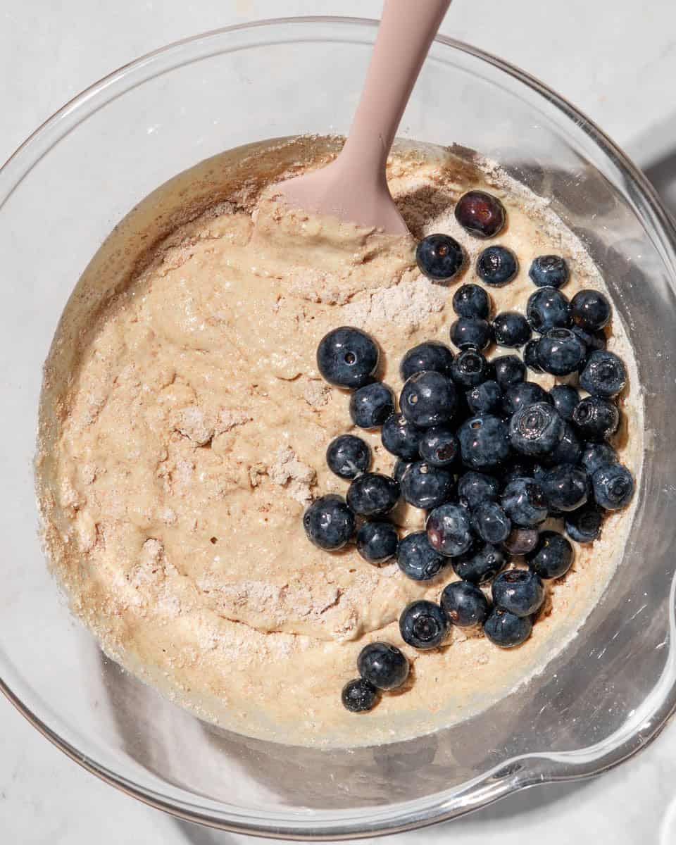 Muffin dough with blueberries folded in.