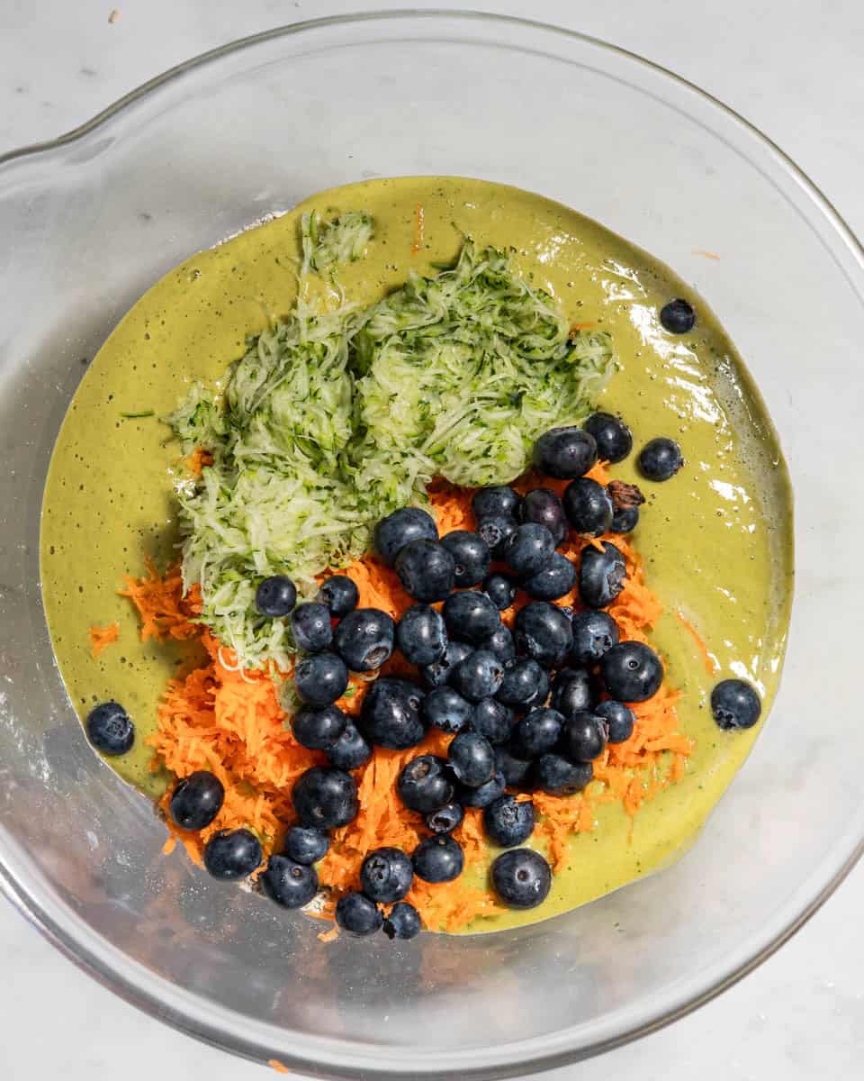 Dry ingredients, wet ingredients, grated zucchini, grated carrots and blueberry folded in.