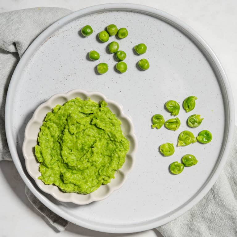 Pea puree, mashed peas and whole cooked peas on a plate.