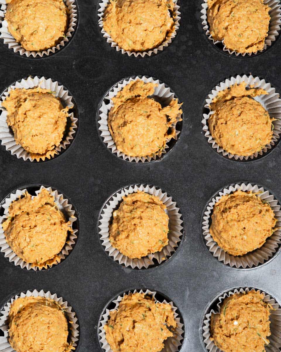 Sweet potato muffins in muffin tin liners ready to be baked.